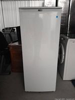 Front exterior view of white upright freezer