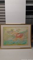 Front view of large framed abstract oil painting showing soft pastel colors and signature Strigan.