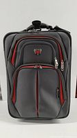 Front view of Swissgear gray fabric suitcase with red accents, showcasing zippered compartments and Swissgear logo.