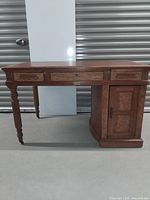 Front view of entire wooden desk on concrete floor