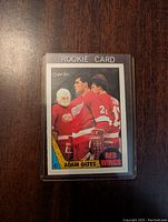 Front of the 1987-88 Adam Oates rookie hockey card showing player in Detroit Red Wings uniform with 'ROOKIE CARD' headline.