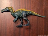 Side view of the Jurassic World Mattel dinosaur figure showing the profile with extended tail and detailed texture.