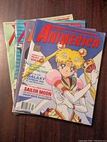 Photo of four Animerica anime magazines featuring Sailor Moon on the cover, stacked and fanned to show all covers.