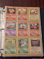 First page showing nine early Pokémon cards in sleeves including Vulpix, Charmander and Electrode
