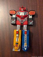 Front view of the 1993 Bandai Power Rangers Mighty Morphin Megazord toy figure showing detailed paint and dinosaur-themed legs.