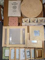 Overview photo showing various wooden frames, mirror frames, silk screens, flower press, flower pots, and paper making kit.