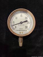 Front view of a 4-inch Dunham vacuum gauge with white face, black numbers, pointer at zero, labeled Morrison Brass, measuring 0-30 lbs per square inch.