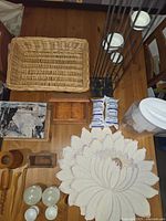 Overview of kitchen items on table including Brita water pitcher, filters, wooden containers, woven basket, candle holder, bowls and placemat