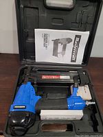Mastercraft air nailer inside plastic carry case with user manual and box of nails
