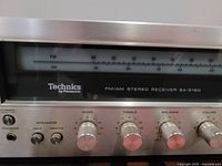 Close-up of the front panel showing Technics by Panasonic branding, model SA-5160, bass, treble, balance, volume knobs, power button, and speaker selectors.
