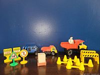 Wide view showing all vehicles, signs, cones, and barricade included in the lot.