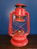 Full view of the red Ever Bright kerosene lantern showing missing glass and overall condition.