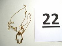 Photo of full necklace with Hamsa hand pendant alongside lot number card.