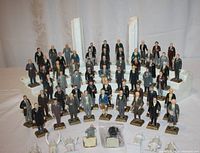Lot includes nearly complete set of 36 painted plastic U.S. Presidents arranged on white Styrofoam display with missing columns, some figures showing wear and one needing repair.
