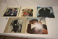 All five album covers displayed face up on a white surface