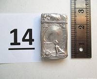 Front view of match safe with lot label and ruler for scale