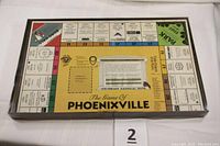Top view of the game board inside the box showing Phoenixville business properties and game path.