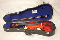 Open violin case showing the violin and bow inside. Violin has visible strings and a slight split at the bottom. Bow is intact but missing strings.