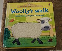Front cover of Woolly's Walk children's touchy-feely board book showing a sheep with tactile wool patch.