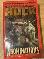 Front cover of The Incredible Hulk Abominations book showing Hulk and Abomination characters on red background.