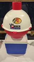 Photo of Bass Pro Shops The Big Bobber Floating Cooler, showing white and red color with logo on front.