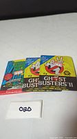 Three sealed vintage movie card packs: two Ghostbusters II and one Teenage Mutant Ninja Turtles.