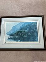 Full front view of the framed print showing the coastal landscape with peregrine falcon and signature.