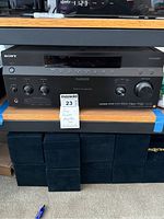 Front view of amplifier on shelf with MaxSold lot tag