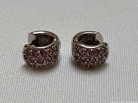 Front view of both earrings side by side showing pink sapphire pavé setting