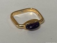 Angled view showing square band profile and amethyst