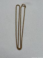 Full chain laid flat on white fabric