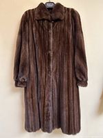 Full front view of the coat hanging on a hanger