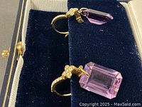 One earring pair in presentation box showing gold lever-back and amethyst drop