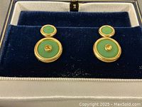 Pair of drop earrings in blue velvet-lined box showing green chrysoprase circles and yellow sapphire centers.