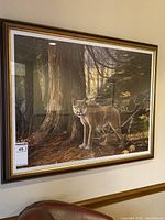 Full view of the framed print depicting a cougar in a forest setting with trees and forest floor, professionally framed.