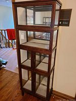 Front view of three stacked modules showing top lift-down panel and double doors at bottom