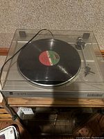 Dual CS 616 Q turntable with hinged acrylic dust cover closed, vinyl record on platter