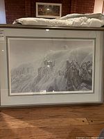 Framed lithographic print with visible matting and frame