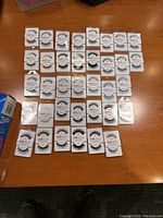 36 pairs of assorted Red Cherry faux eyelashes arranged in rows on a table, showing variety of styles.