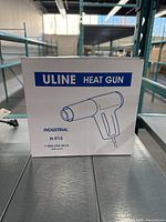 Box of Uline Industrial Heat Gun model H-915 with label and illustration.