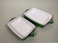 Overhead view of both rectangular pans showing white interior and green exterior.