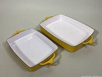 Both pans angled top view showing exterior and interior colors