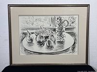 Full framed print showing still life composition of ceramic jug, bowl of grapes, and fruit on table with window background. Includes signature and numbering.