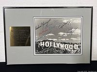 Framed Hollywood Sign photograph with autographs and metal plaque listing signers.
