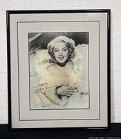 Framed 14x12 inch Lana Turner signed print showing full front view with black frame and white double matting.