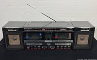 Front view of the vintage JVC PC-W88 portable component system showing dual cassette decks, speakers, radio tuner panel, and control buttons.
