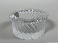 Clear and frosted spiral ribbed crystal ashtray, side angle showing shape and texture