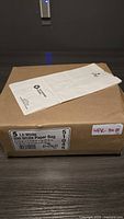 Box of 500 white paper bags stacked with one bag displayed on top showing size and brand information