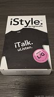 Front of box showing the black T-shirt with white text 'iTalk. uListen.', size large, and iStyle Originals branding.