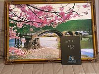 Frontal view of the framed cherry blossom bridge print showing full artwork and frame details.